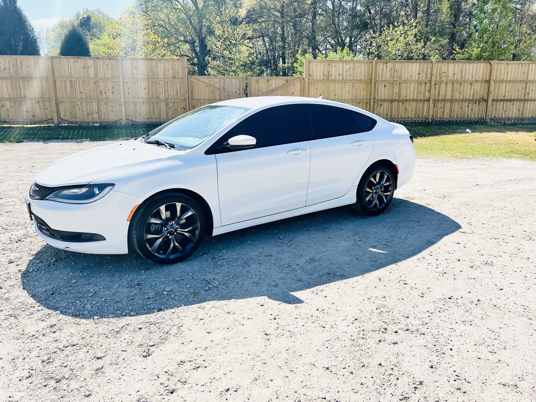 White Chrysler sedan with dark wheels on our lot